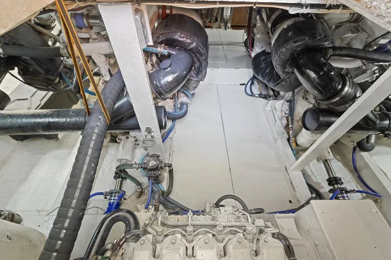 Bella Yacht Photos Pics Engine room of a 1978 Hatteras 45 Convertible boat, showcasing mechanical components.