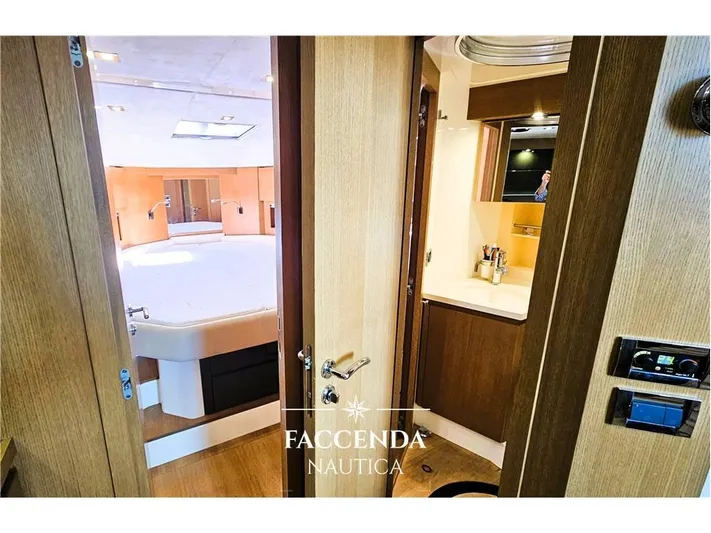  Yacht Photos Pics Luxurious interior of 2013 Azimut Atlantis 44 yacht, featuring a cozy bedroom and modern bathroom.