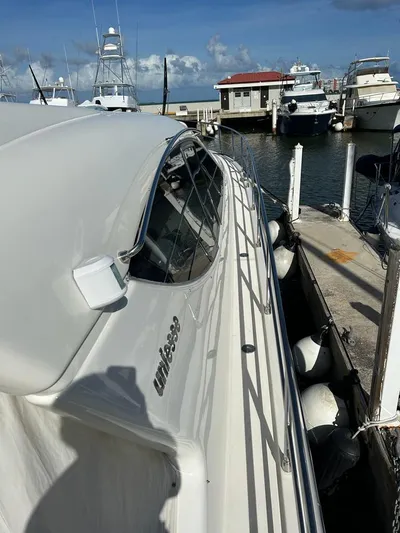 Side Effeot Yacht Photos Pics 2007 Uniesse 54 Sport yacht docked at a marina on a sunny day.