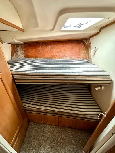 Goggle Eye Yacht Photos Pics 2000 Luhrs 400 Convertible cabin with striped bunk beds and wooden cabinetry.
