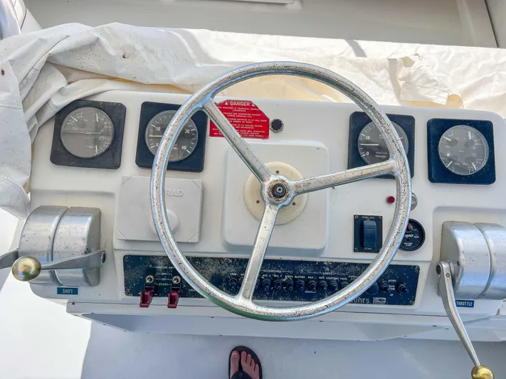 Goggle Eye Yacht Photos Pics 2000 Luhrs 400 Convertible boat helm with steering wheel and control panel.