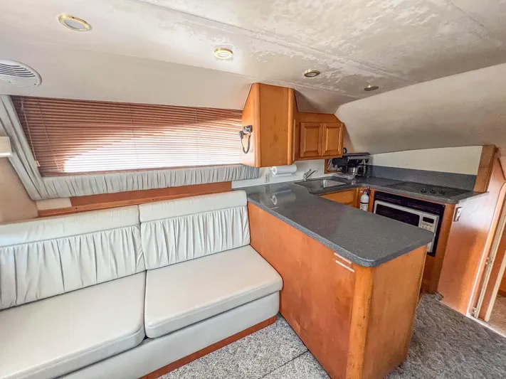 Goggle Eye Yacht Photos Pics Interior of 2000 Luhrs 400 Convertible yacht with kitchen and seating area.