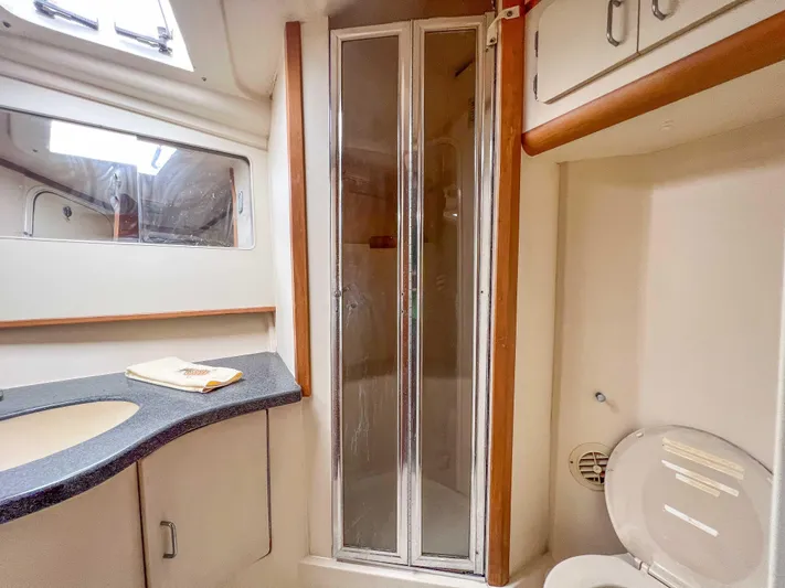 Goggle Eye Yacht Photos Pics 2000 Luhrs 400 Convertible yacht bathroom with shower, sink, and toilet.