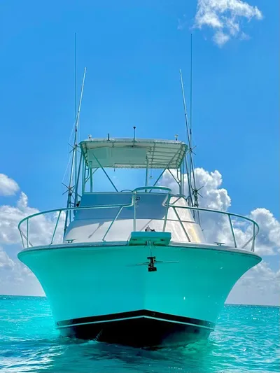 Goggle Eye Yacht Photos Pics 2000 Luhrs 400 Convertible boat on clear blue water.