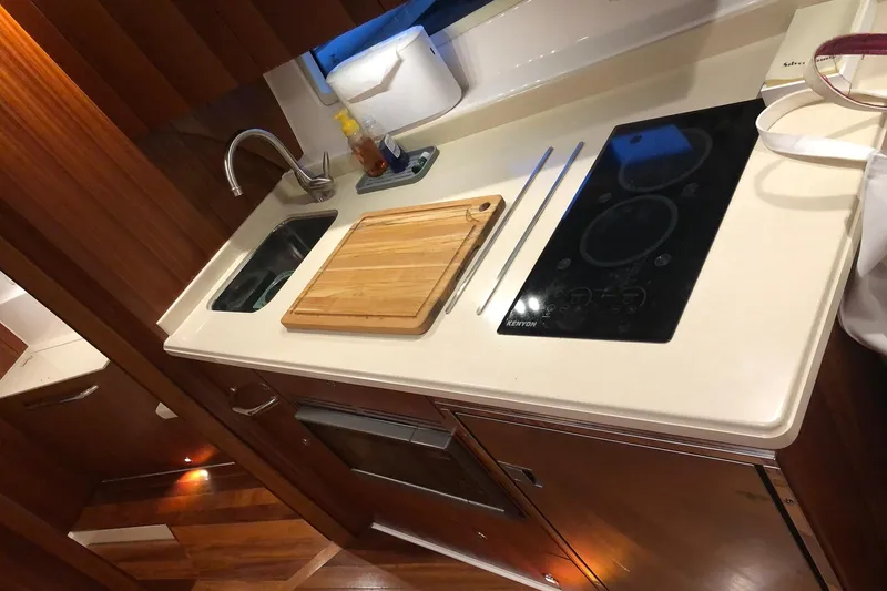 Silver Lining Yacht Photos Pics Modern kitchen in 2017 Tiara Yachts C39 Coupe with sink, stove, and cutting board.