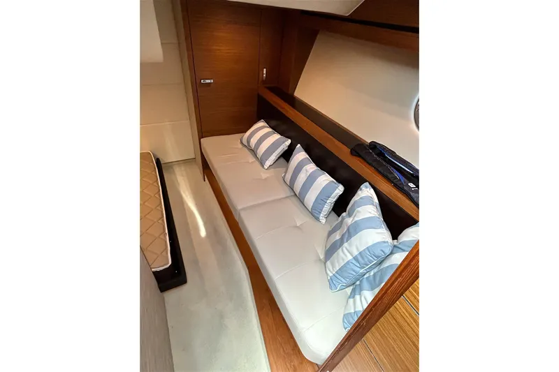 Silver Lining Yacht Photos Pics 2017 Tiara Yachts C39 Coupe interior with striped cushions and wooden accents.