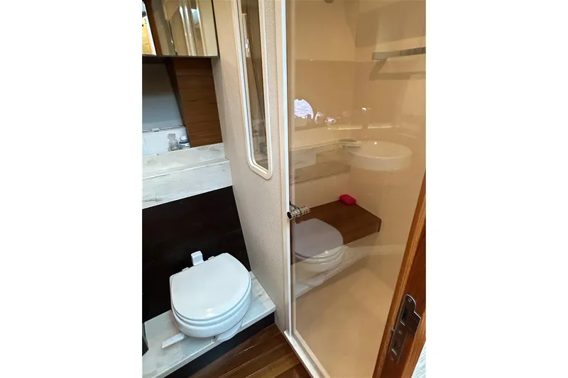 Silver Lining Yacht Photos Pics Bathroom interior of 2017 Tiara Yachts C39 Coupe with modern fixtures and wooden accents.