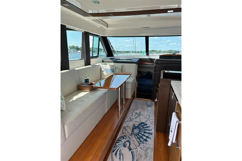 Silver Lining Yacht Photos Pics Luxurious interior of 2017 Tiara Yachts C39 Coupe with elegant seating and panoramic windows.