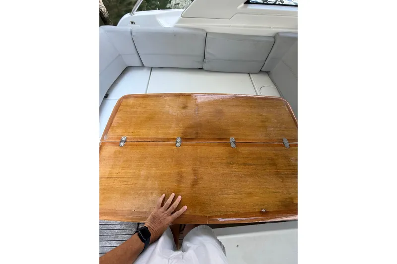  Yacht Photos Pics 2013 Beneteau Flyer GT 34 cockpit with wooden table and cushioned seating.