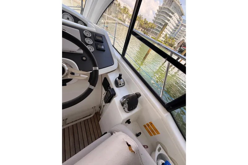  Yacht Photos Pics Interior view of 2013 Beneteau Flyer GT 34 boat cockpit with steering wheel and controls.