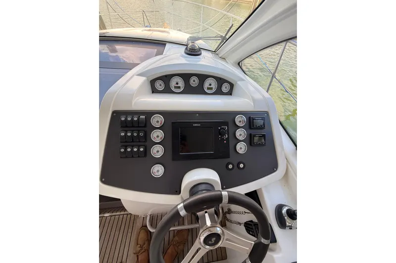  Yacht Photos Pics 2013 Beneteau Flyer GT 34 helm with steering wheel and control panel.