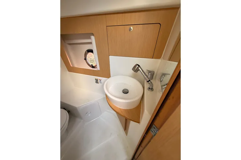  Yacht Photos Pics 2013 Beneteau Flyer GT 34 bathroom with sink, faucet, and porthole window.