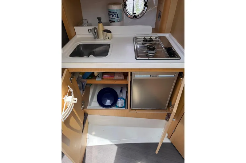  Yacht Photos Pics Compact kitchen in 2013 Beneteau Flyer GT 34 with sink, stove, and storage.