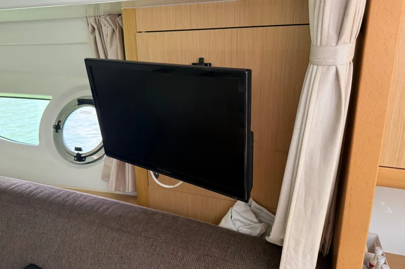 Yacht Photos Pics Interior of 2013 Beneteau Flyer GT 34 with mounted TV and porthole window.