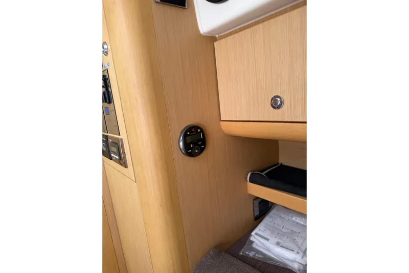  Yacht Photos Pics Interior of 2013 Beneteau Flyer GT 34, featuring wooden cabinetry and control panel.