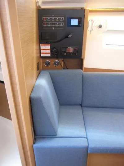  Yacht Photos Pics Interior of 2025 Jeanneau Sun Odyssey 350 yacht with blue seating and control panel.