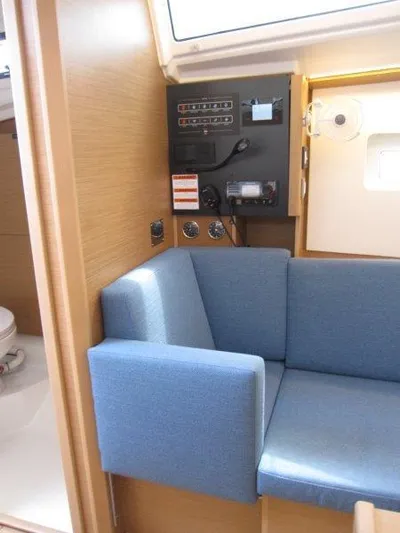  Yacht Photos Pics Interior of 2025 Jeanneau Sun Odyssey 350 yacht with blue seating and control panel.