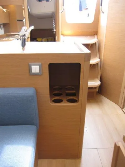  Yacht Photos Pics Interior of 2025 Jeanneau Sun Odyssey 350 yacht with wooden finish and cup holders.