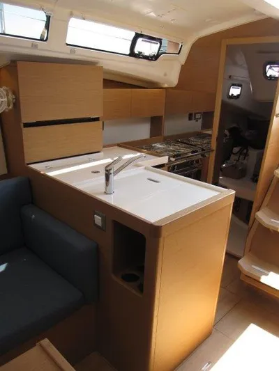  Yacht Photos Pics Interior of 2025 Jeanneau Sun Odyssey 350 yacht, featuring modern kitchen and seating area.