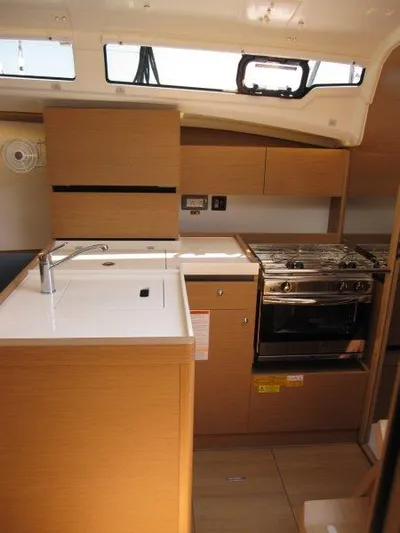  Yacht Photos Pics 2025 Jeanneau Sun Odyssey 350 yacht kitchen with modern appliances and wood finish.