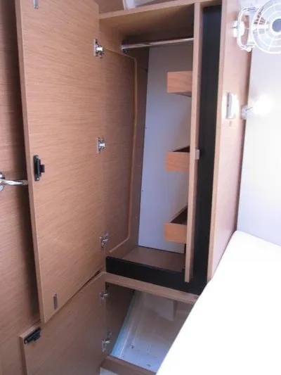  Yacht Photos Pics 2025 Jeanneau Sun Odyssey 350 interior storage cabinets with wooden finish.