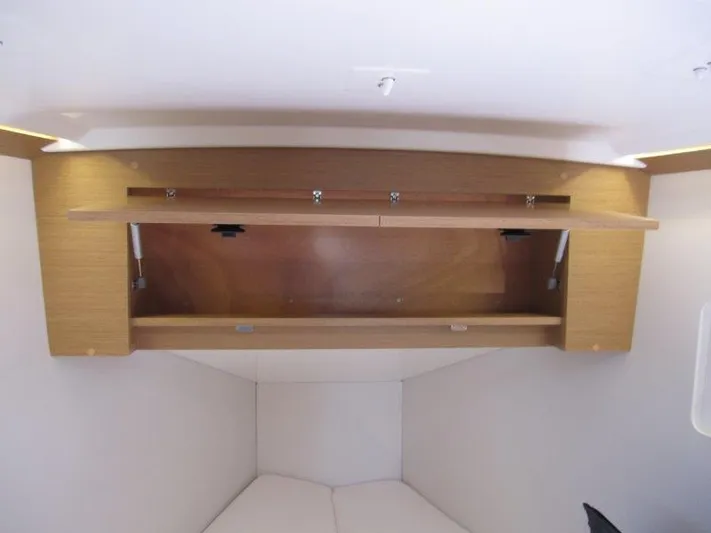  Yacht Photos Pics Interior storage compartment in 2025 Jeanneau Sun Odyssey 350 sailboat cabin.