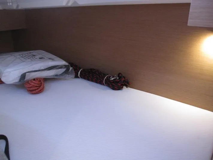  Yacht Photos Pics Cozy interior of 2025 Jeanneau Sun Odyssey 350 with ropes and soft lighting.