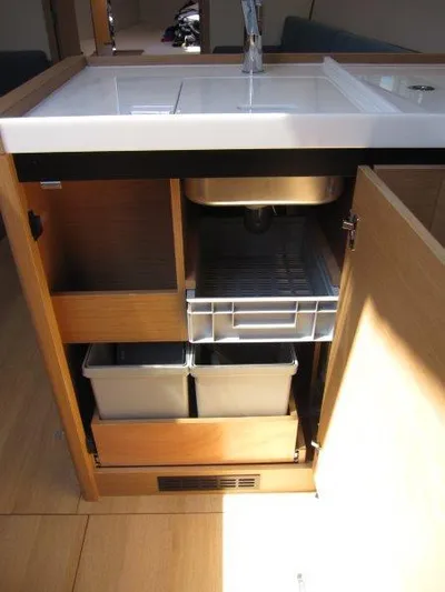  Yacht Photos Pics 2025 Jeanneau Sun Odyssey 350 yacht kitchen with sink, storage, and modern cabinetry.