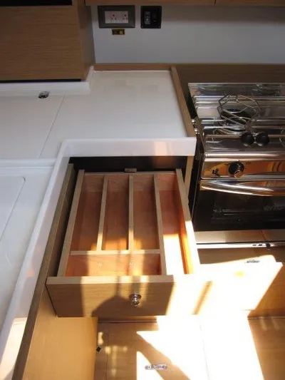 Yacht Photos Pics 2025 Jeanneau Sun Odyssey 350 kitchen with open drawer and stove.