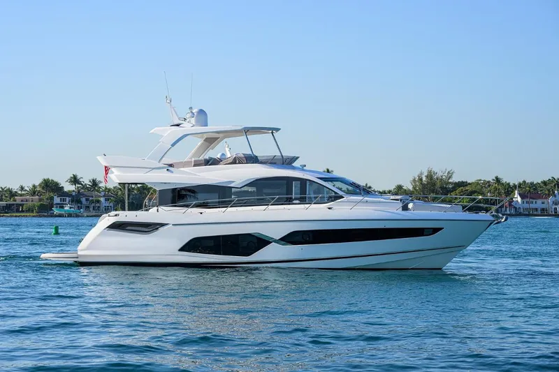 Lucky Ladies Yacht Photos Pics 2022 Sunseeker Manhattan 68 yacht cruising on calm waters.