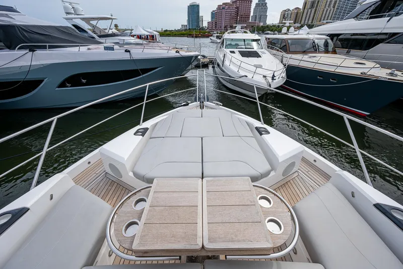Lucky Ladies Yacht Photos Pics Sunseeker Manhattan 68 yacht, 2022 model, docked among other luxury boats in a marina.