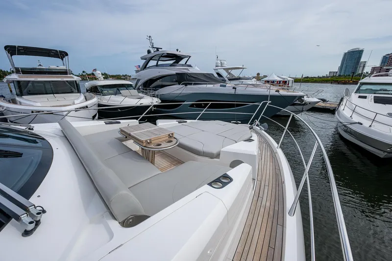 Lucky Ladies Yacht Photos Pics Luxury Sunseeker Manhattan 68 yacht, 2022 model, docked among other boats in a marina.