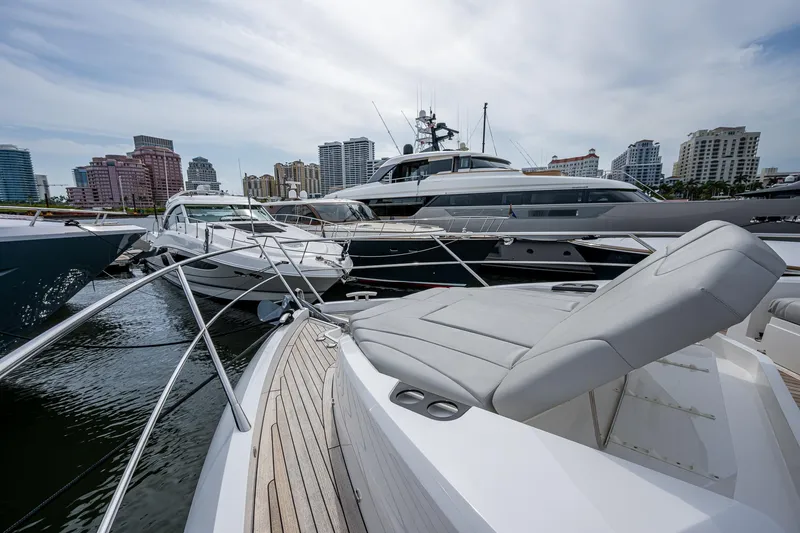 Lucky Ladies Yacht Photos Pics Sunseeker Manhattan 68 yacht, 2022 model, docked in a marina with city skyline backdrop.