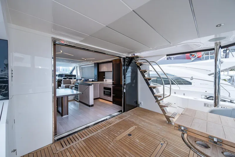 Lucky Ladies Yacht Photos Pics Luxurious Sunseeker Manhattan 68 yacht interior, featuring modern kitchen and elegant wooden deck, 2022 model.