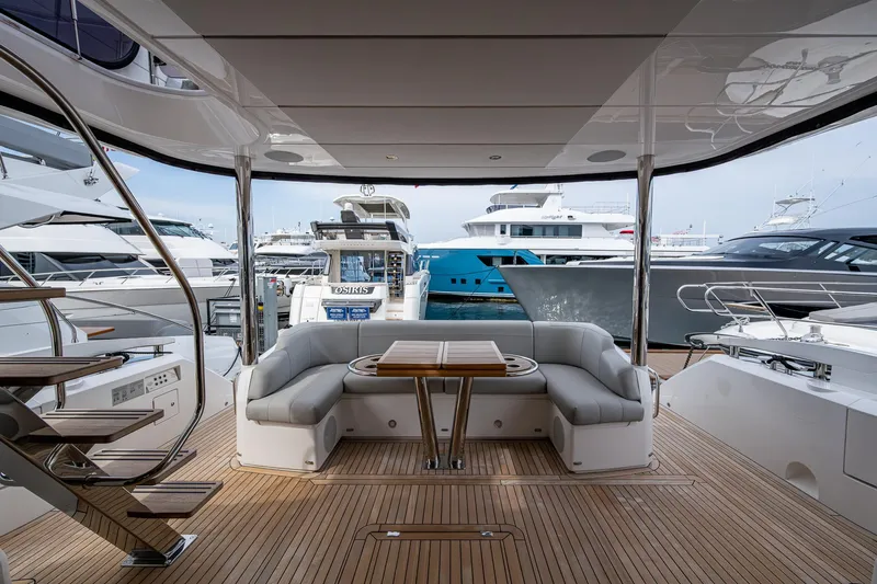 Lucky Ladies Yacht Photos Pics 2022 Sunseeker Manhattan 68 yacht interior with elegant seating and wooden deck.