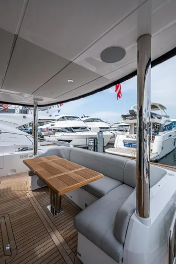 Lucky Ladies Yacht Photos Pics Luxury Sunseeker Manhattan 68 yacht deck with seating, docked at marina, 2022 model.