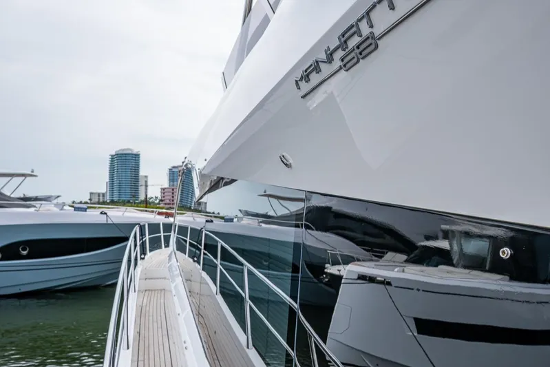 Lucky Ladies Yacht Photos Pics 2022 Sunseeker Manhattan 68 yacht docked with city skyline in background.