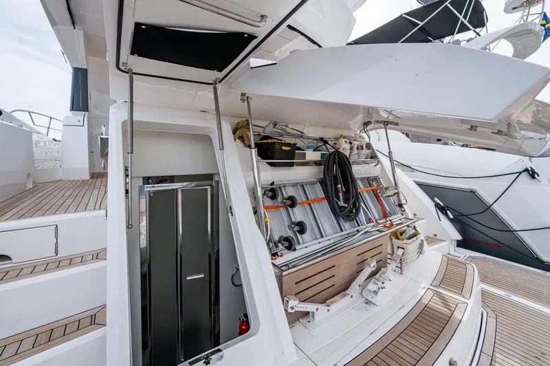 Lucky Ladies Yacht Photos Pics Sunseeker Manhattan 68 yacht, 2022 model, showcasing open storage compartment and deck area.