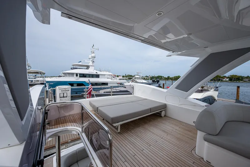 Lucky Ladies Yacht Photos Pics Luxurious 2022 Sunseeker Manhattan 68 yacht deck with seating and scenic marina view.