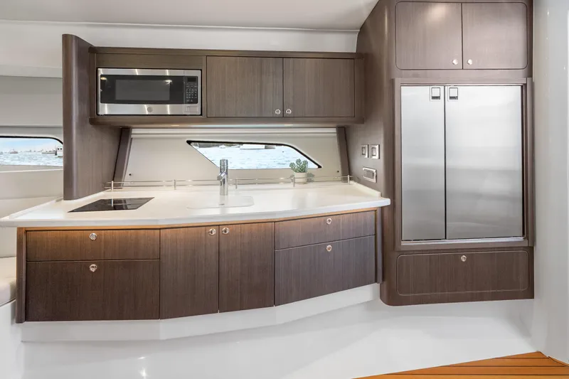  Yacht Photos Pics Luxurious kitchen interior of 2024 Intrepid 477 Evolution yacht with modern appliances.