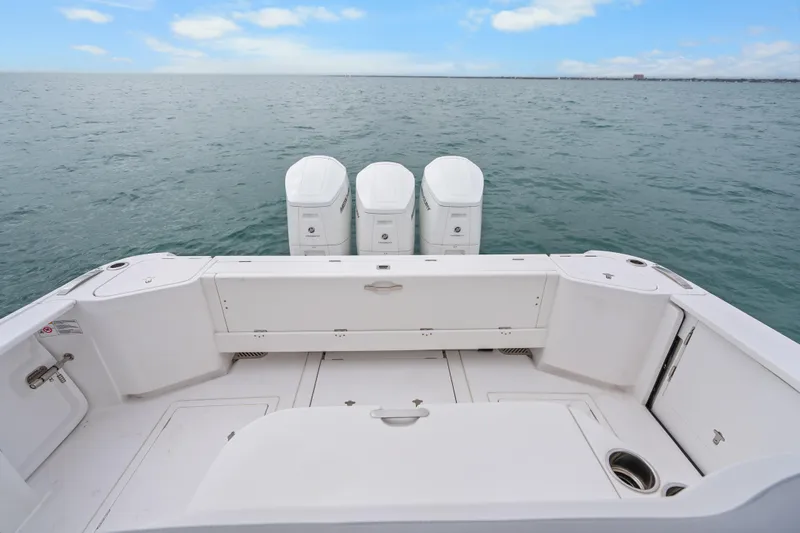  Yacht Photos Pics 2024 Intrepid 477 Evolution boat with triple outboard engines on open water.