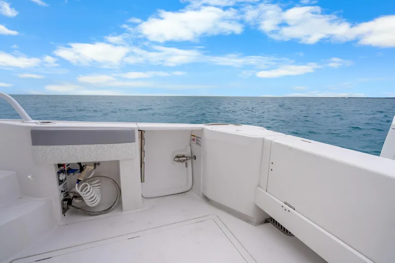  Yacht Photos Pics 2024 Intrepid 477 Evolution boat deck with ocean view and blue sky.