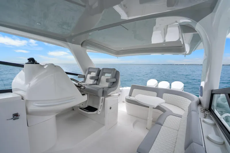  Yacht Photos Pics 2024 Intrepid 477 Evolution boat interior with modern seating and ocean view.