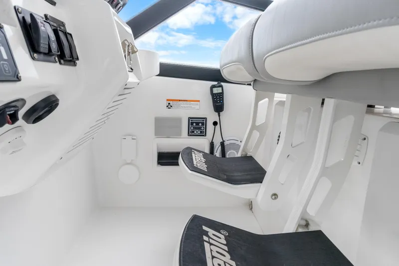  Yacht Photos Pics 2024 Intrepid 477 Evolution helm with controls and seating, featuring modern design elements.