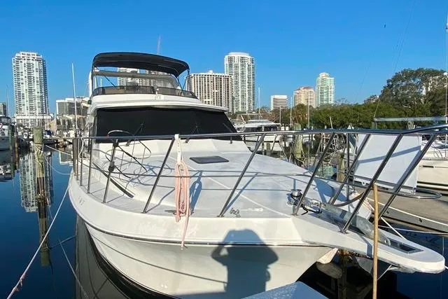 Thistle Do Nicely Yacht Photos Pics 1997 Navigator 4200 yacht docked in urban marina with city skyline.