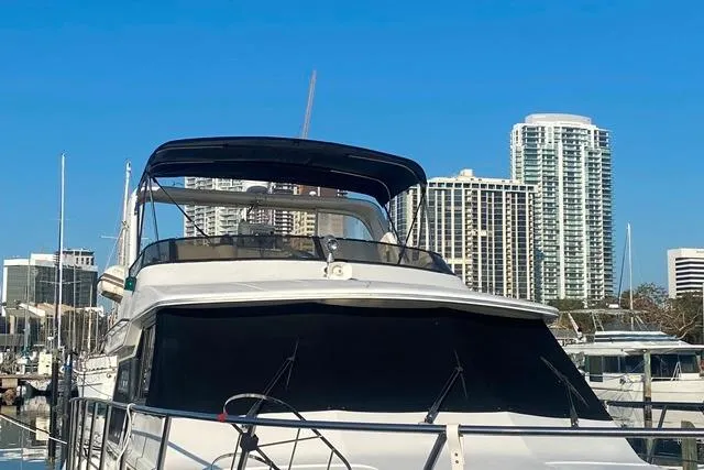 Thistle Do Nicely Yacht Photos Pics 1997 Navigator 4200 yacht docked with city skyline in background.