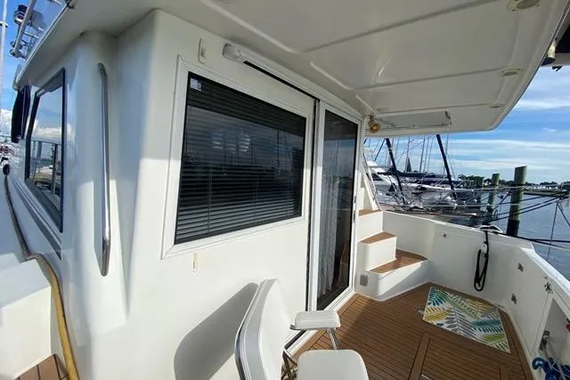 Thistle Do Nicely Yacht Photos Pics 1997 Navigator 4200 yacht deck with seating, steps, and marina view.