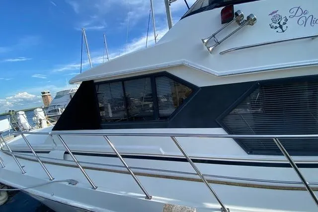 Thistle Do Nicely Yacht Photos Pics 1997 Navigator 4200 yacht with sleek design, docked under clear blue sky.