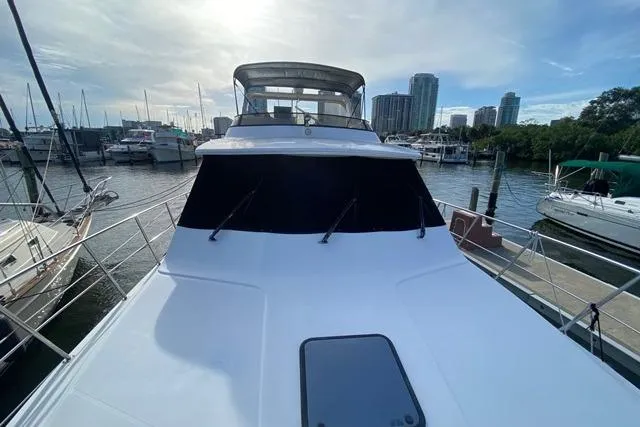 Thistle Do Nicely Yacht Photos Pics 1997 Navigator 4200 yacht docked at marina with city skyline in background.