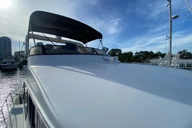 Thistle Do Nicely Yacht Photos Pics 1997 Navigator 4200 yacht with sleek design, docked under a clear blue sky.